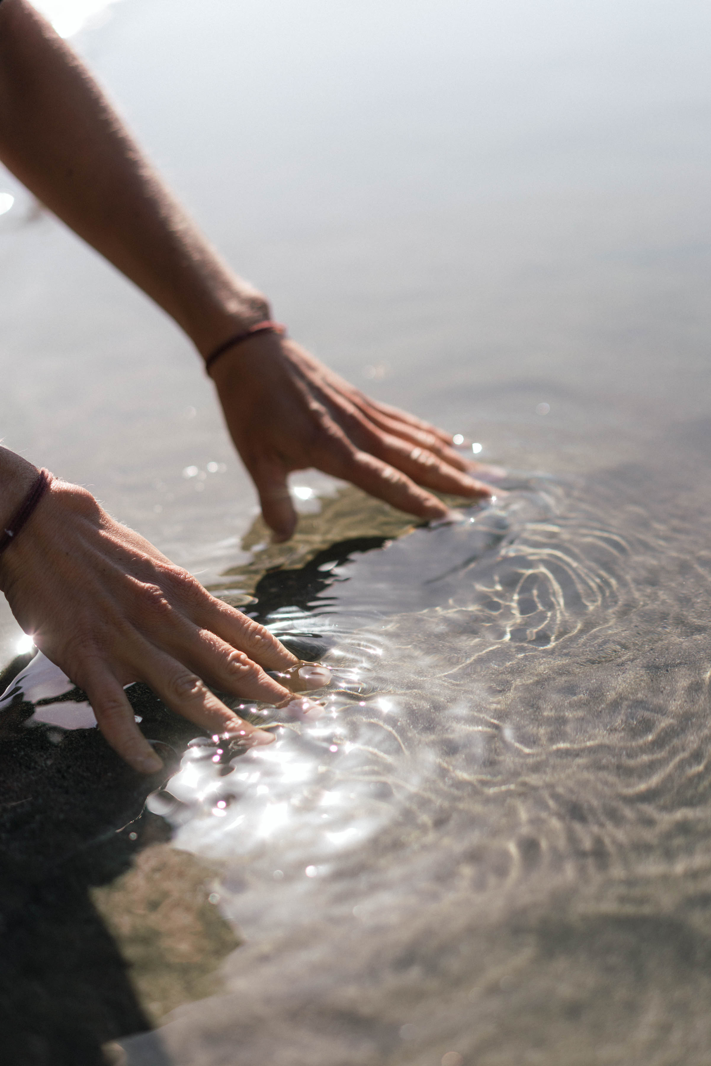 Hands touching water